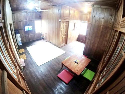 an overhead view of a room with a table and chairs at Degolan Wooden House in Ngemplak