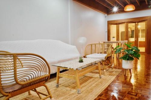 a bedroom with a bed and a table and chairs at Home Story Hostel Chiang Mai in Chiang Mai
