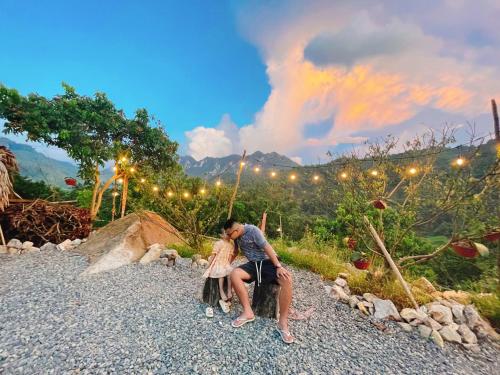 a woman sitting on a rock in the mountains at Mường Sang Retreat in Mộc Châu