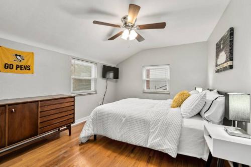 a bedroom with a bed and a ceiling fan at Spacious Home, 15min from Downtown, Private Garage & Patio in Pittsburgh