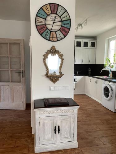 a kitchen with a clock on the wall and a sink at Veselka in Dolní Bousov