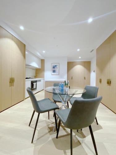 a kitchen and dining room with a table and chairs at Box Hill Central Sky One Apartment in Box Hill