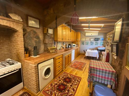 a kitchen with a stove and a washer and dryer at Stone House with Garden in Cunda/Ayvalik in Ayvalık