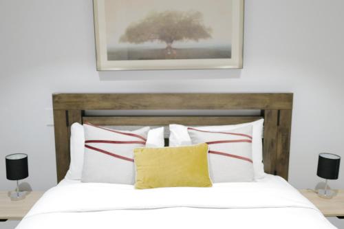 a bedroom with a bed with red and white pillows at Box Hill Central Sky One Apartment in Box Hill