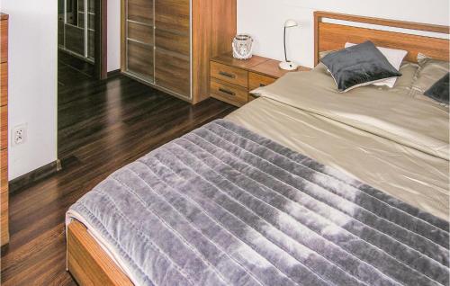 a bedroom with a large bed and a dresser at Apartment Beautiful in Ostróda