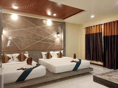 A bed or beds in a room at Lanta Pearl Beach Resort