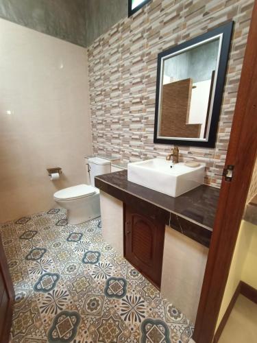a bathroom with a sink and a toilet at Lanta Pearl Beach Resort in Ko Lanta