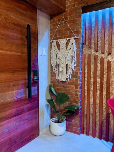 a plant in a pot next to a door at Blue Tulip - 4mins from Mactan Airport in Pusok