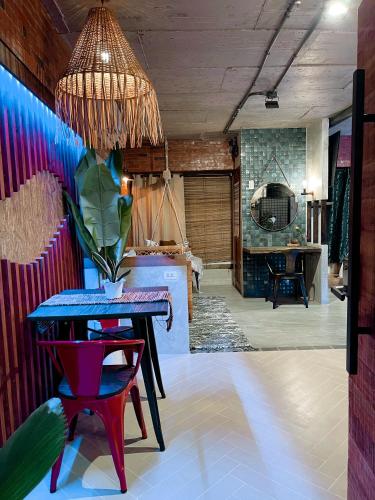 a dining room with a table and a room with a fireplace at Blue Tulip - 4mins from Mactan Airport in Pusok