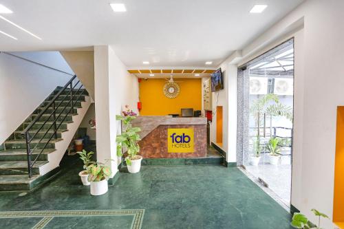 a lobby with stairs and plants in a building at Via The Prasiddh in Agra