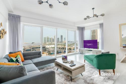 a living room with a couch and a tv at Dream Inn Dubai - Damac Heights Marina in Dubai