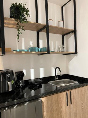 a kitchen with a sink and a counter top at HOTEL 9.5 SAN FERNANDO in Cali