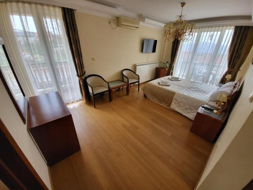 a bedroom with a bed and a table and chairs at Sunny Hill Apartments & Aqua Park in Vrnjačka Banja