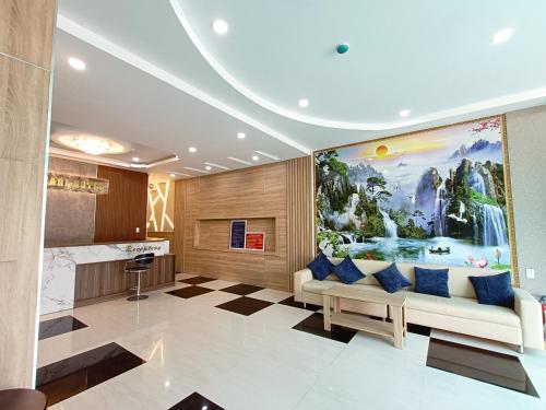 uma sala de estar com um sofá e uma pintura na parede em SixPearl Hotel em Con Dao