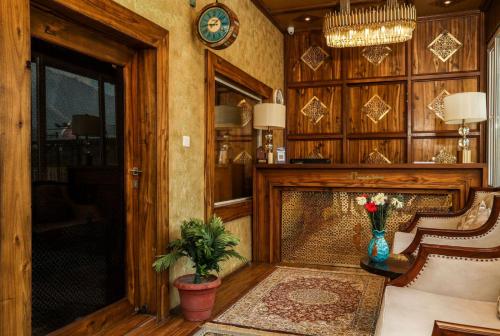 a living room with a chair and a fireplace at Arco Hotels & Resorts sonamarg in Sonāmarg