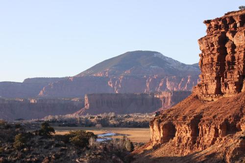 a view of a canyon with a mountain in the background at Red Sands Hotel in Torrey