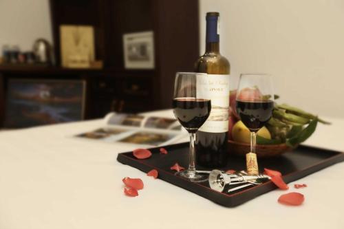 a bottle of wine and two glasses on a table at Golden Sail Hotel & Spa in Hanoi