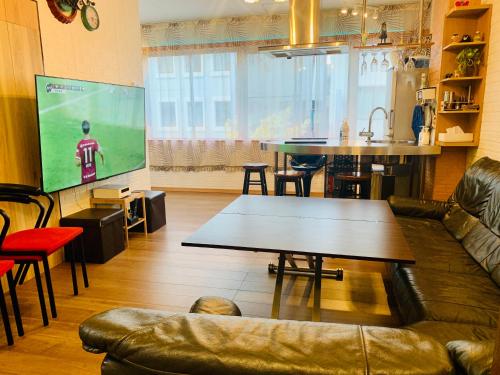 a living room with a couch and a table at YokohamaKannai HouseBar in Yokohama