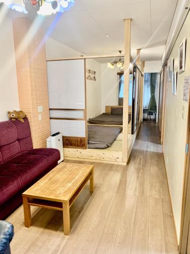 a living room with a couch and a bed at YokohamaKannai HouseBar in Yokohama