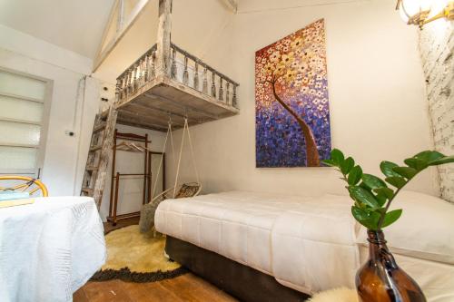 a bedroom with a bed and a painting on the wall at Silsopa Hostel in Nong Khai