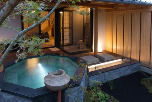 a swimming pool in front of a house at Saginoyusou in Yasugi