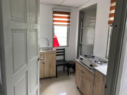 a small kitchen with a sink and a window at Heaven republic Studio in Kangar