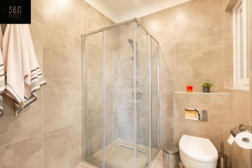 a shower stall in a bathroom with a toilet at LIVE like a Local - 3 Cities Home & 2 KING BED by 360 Estates in Cospicua