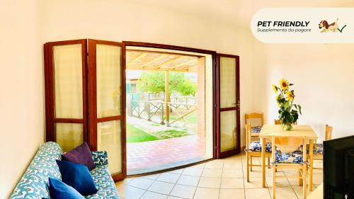 a living room with a sliding glass door at Casa in Maremma Tuscany Village in Scarlino