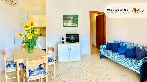 a living room with a couch and a table at Casa in Maremma Tuscany Village in Scarlino