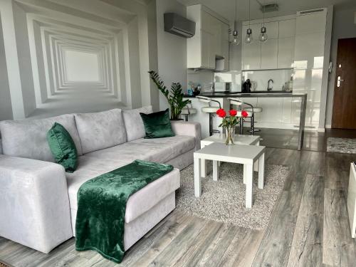 a living room with a couch and a table at Apartament Winnica in Toruń