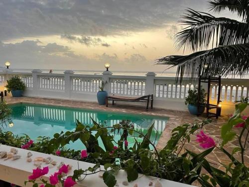 a resort pool with a view of the ocean at Mambo Paradise in Matemwe