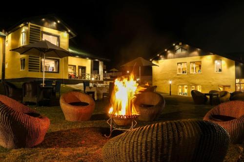 a fire pit in front of a house at night at Arco Hotels & Resorts sonamarg in Sonāmarg