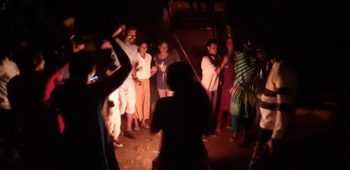 a group of people standing in a dark room at GB 25 Cottage in Trivandrum