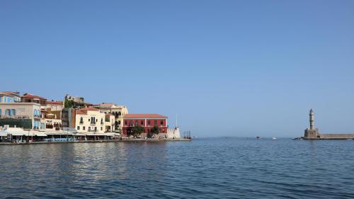 a group of buildings on the shore of a body of water at Thyme Sea View Apartments by 8essentially in Souda