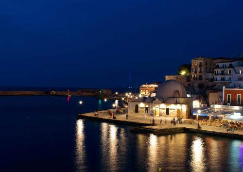 a view of a city at night with the water at Thyme Sea View Apartments by 8essentially in Souda