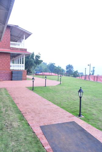 a group of lights in a field next to a building at Regenta Place Green Leaf Mahabaleshwar in Mahabaleshwar