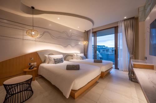 Postel nebo postele na pokoji v ubytování Metadee Concept Hotel