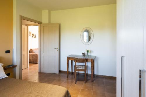 a bedroom with a table and a mirror on the wall at Incanto Toscano in Larciano