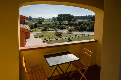 a room with a window with a table and chairs at Incanto Toscano in Larciano