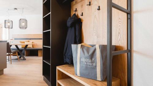 a shopping bag is sitting on a shelf in a room at alpina&more APARTMENTS I ZIMMER in Serfaus