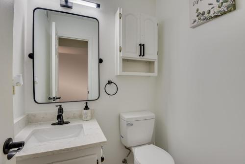 a white bathroom with a sink and a mirror at Beautiful 3BR Townhouse Close to Downtown Augusta in Augusta