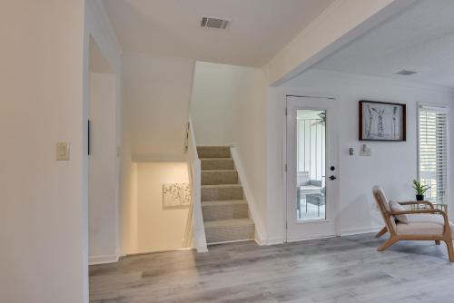 a living room with stairs and a chair at Beautiful 3BR Townhouse Close to Downtown Augusta in Augusta