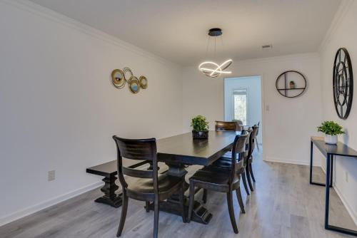 a dining room with a table and chairs at Beautiful 3BR Townhouse Close to Downtown Augusta in Augusta
