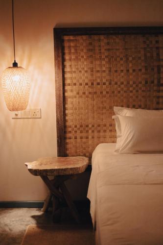 a bedroom with a bed and a table next to a bed at Manta Reserve in Maalhos