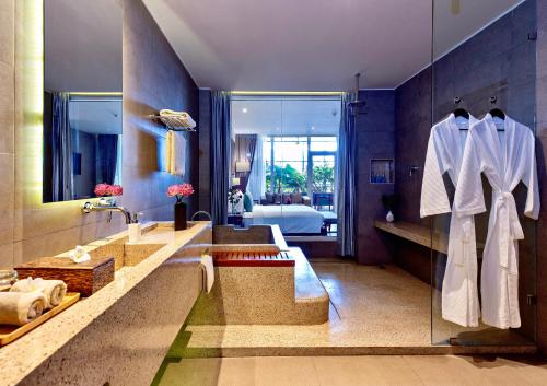 a bathroom with two sinks and a large mirror at Indra Hotel in Phnom Penh
