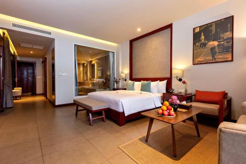 a hotel room with a bed and a living room at Indra Hotel in Phnom Penh