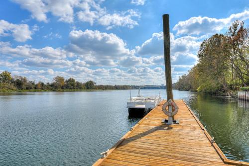 a boat is docked at a dock on a river at Beautiful 3BR Townhouse Close to Downtown Augusta in Augusta