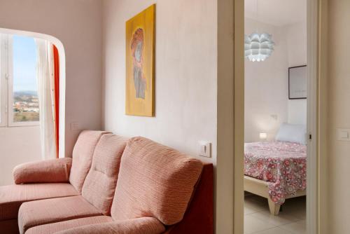 a living room with a couch and a bedroom at Casa Ferro in Las Palmas de Gran Canaria