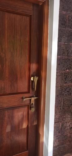 a wooden door with a knob on it at Namaste Yoga Farm in Gokarna