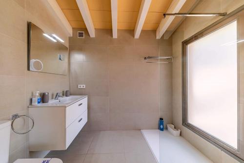 baño con lavabo y aseo y ventana en Villa Can Sort, en Sóller